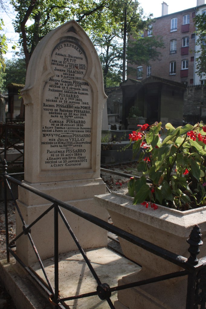 All alone, with no tourists in sight, Camille Pissarro and family's grave