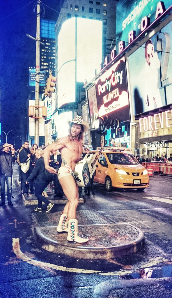 The Naked Cowboy entertaining the crowds...