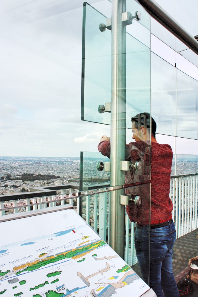 Malek taking a photograph whilst trying not to drop his camera from the great hight!